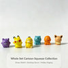 A collection of six colorful cartoon and fantasy creature mini figurines displayed on a white surface.