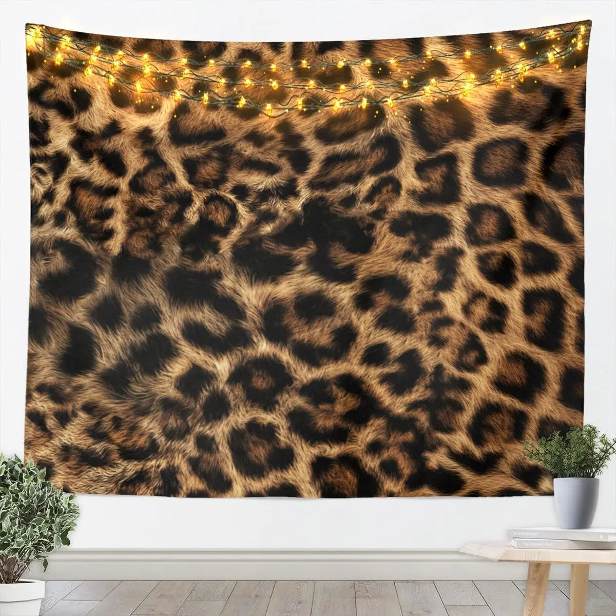 A dark tapestry wall hanging featuring a leopard print pattern with warm string lights.