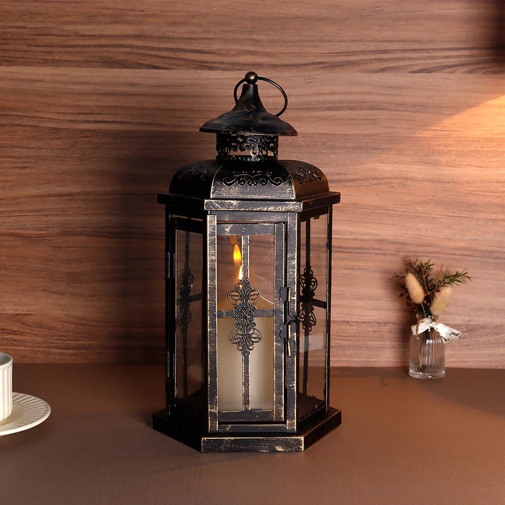A vintage Nordic iron candle lantern with glass panes sits on a brown surface against a wooden background.