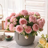 A bouquet of pink silk peony roses in a gray pot, suitable for weddings and home decor.