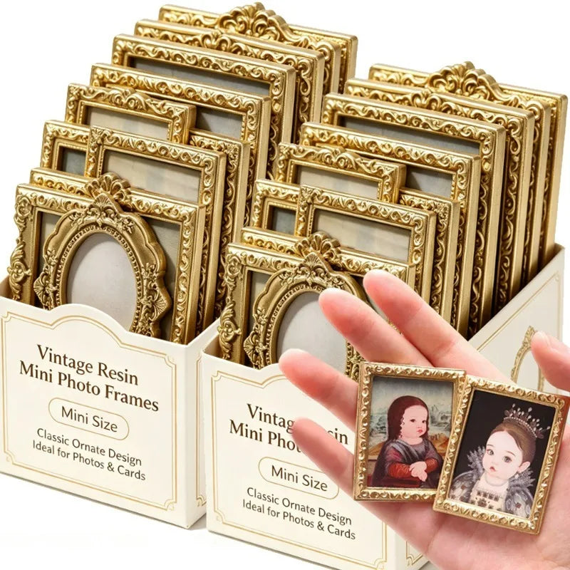 A hand holds a set of gold-colored vintage resin mini photo frames for crafting and display.