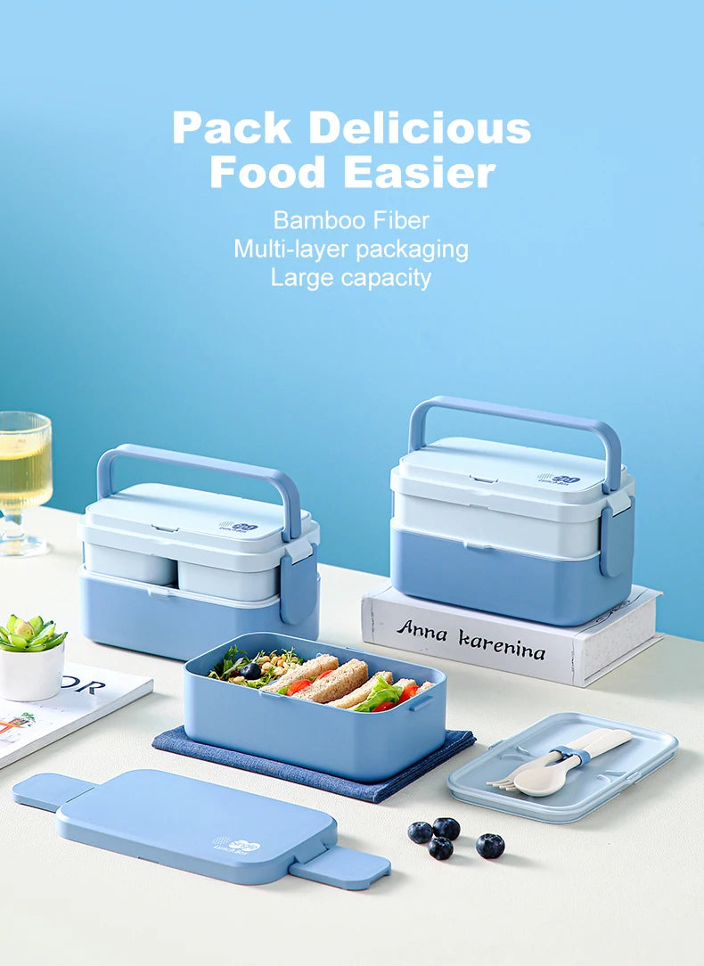 A blue bamboo fiber multi-layer bento lunch box with a lid and accompanying utensils is displayed on a white surface.
