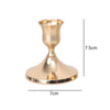 A vintage brass iron candlestick holder with a flared base and cup, shown in a side view.