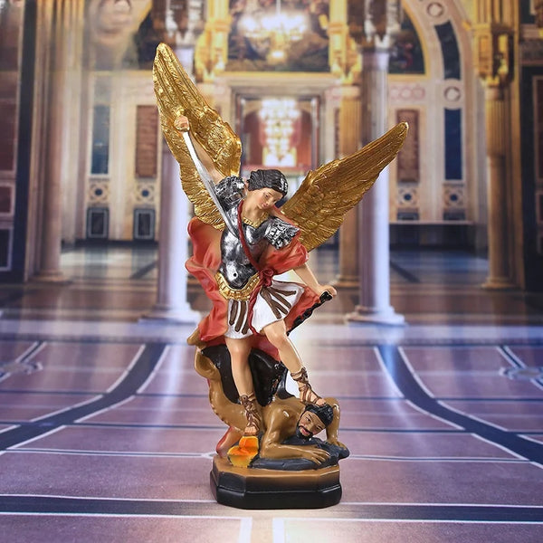 Bronzed Saint Michael Archangel resin figurine with golden wings and red robes standing on a dark base.