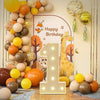A display of gold and orange balloons arranged in a vertical tower with a large illuminated number one balloon frame.