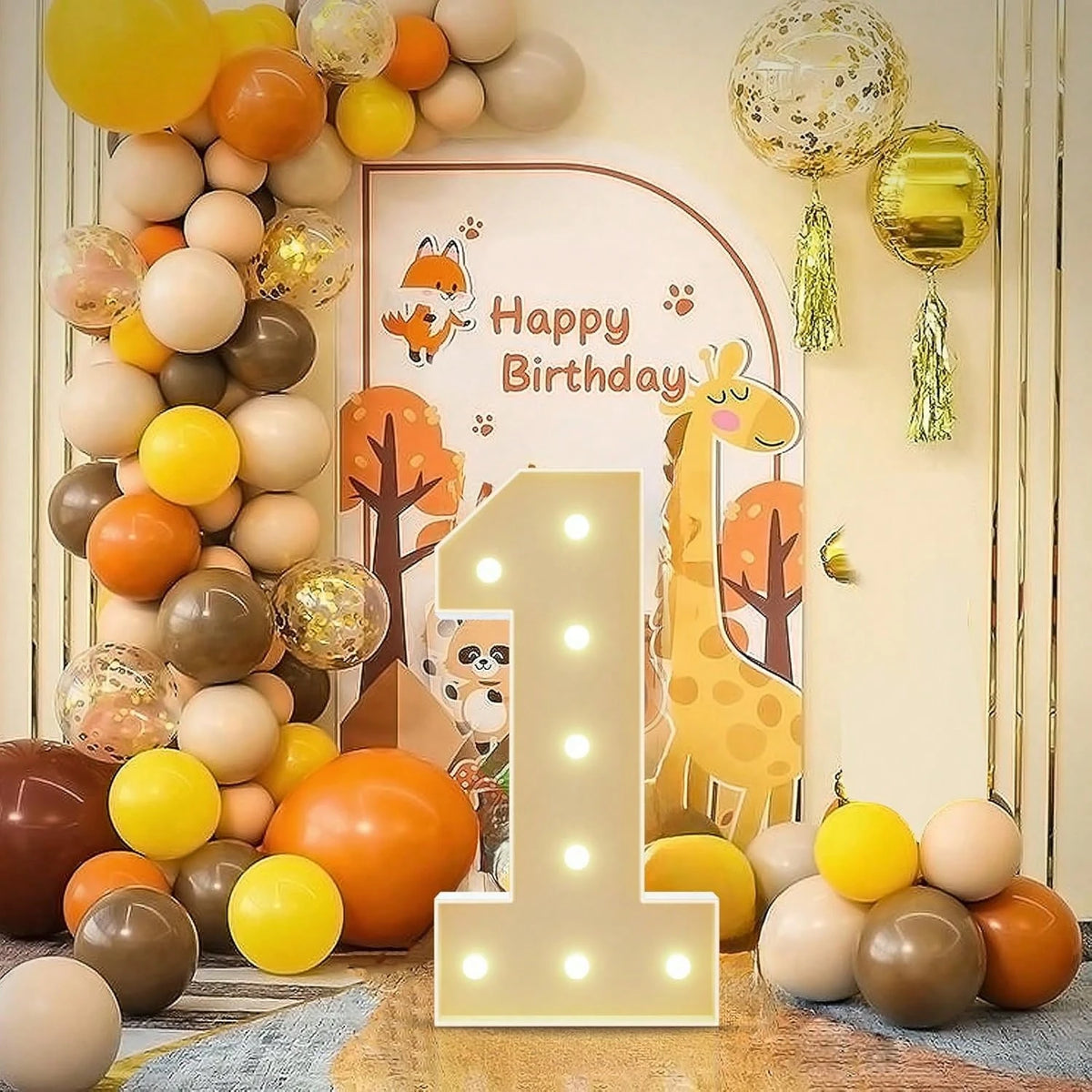 A display of gold and orange balloons arranged in a vertical tower with a large illuminated number one balloon frame.