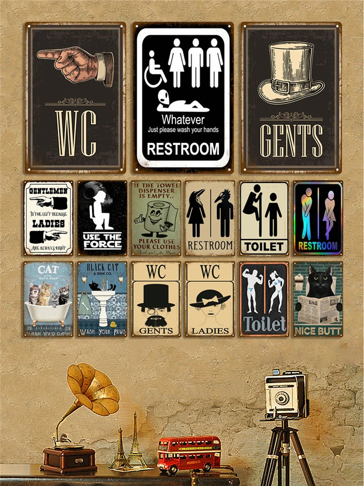 A collection of vintage metal signs featuring humorous and classic bathroom themes like WC, gents, ladies, and toilet.
