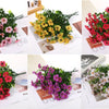 Bundles of colorful artificial daisy flowers in various shades including pink, yellow, red, and white.