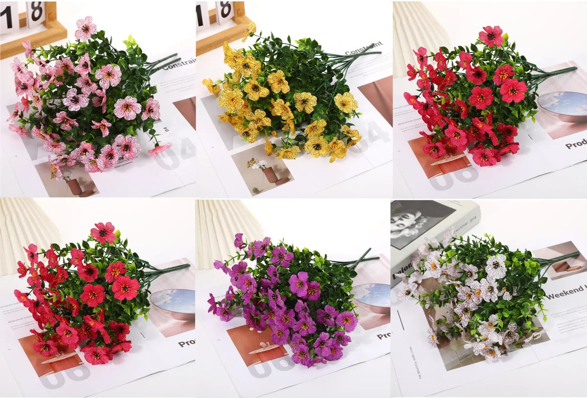 Bundles of colorful artificial daisy flowers in various shades including pink, yellow, red, and white.