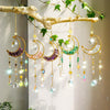 Handcrafted moon crystal suncatcher featuring various colored crystals and prism pendants hanging from a natural branch.