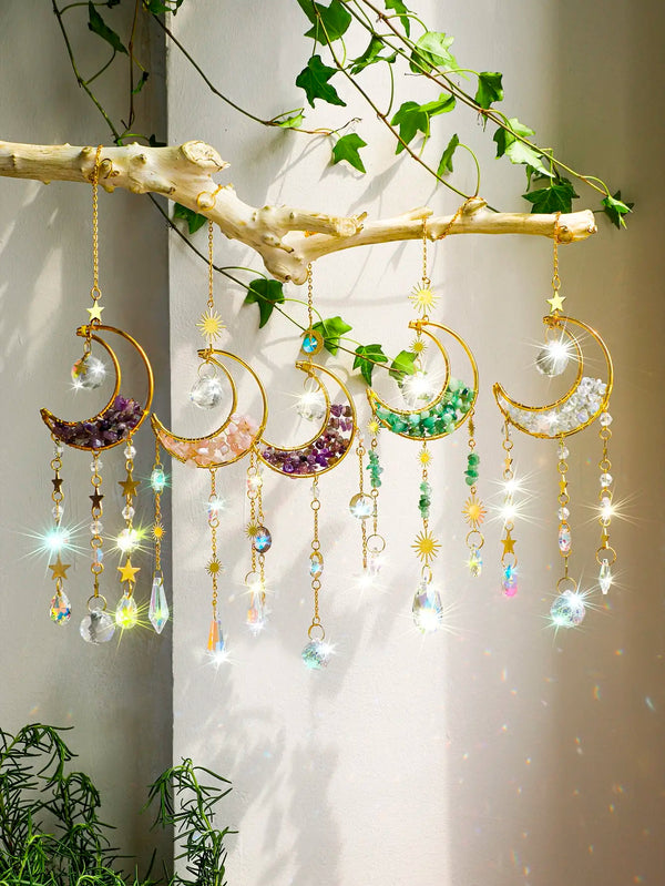 Handcrafted moon crystal suncatcher featuring various colored crystals and prism pendants hanging from a natural branch.