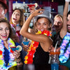 A group of people celebrating with glow-in-the-dark LED Hawaiian lei necklaces and colorful drinks.