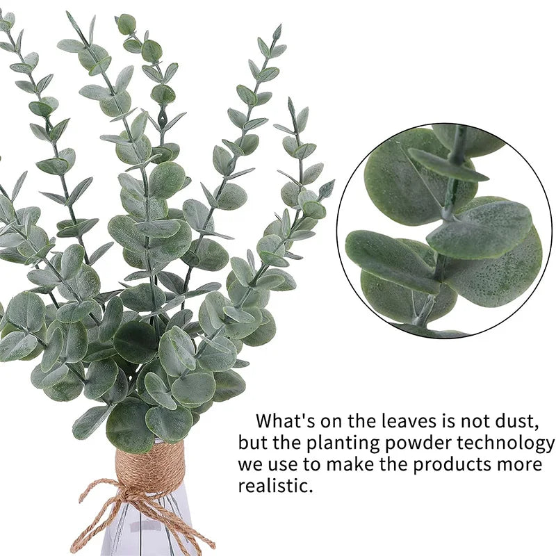 A bundle of artificial eucalyptus leaves with dusty green foliage displayed in a vase.