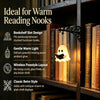 Vintage gothic bookshelf reading lamp with a white light illuminating stacked books.