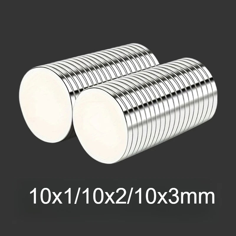 A pair of silver disc magnets with various thicknesses shown against a dark background.