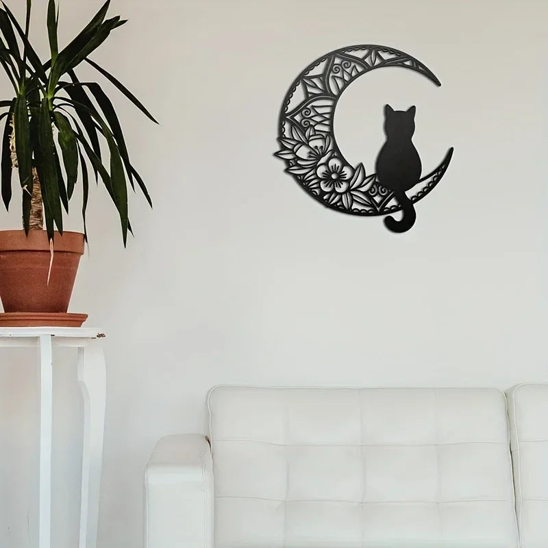 Black cat silhouette inside a crescent moon design wall decor sculpture on a white wall