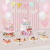 Clear acrylic cake display stands with various desserts and balloons for a candy bar theme