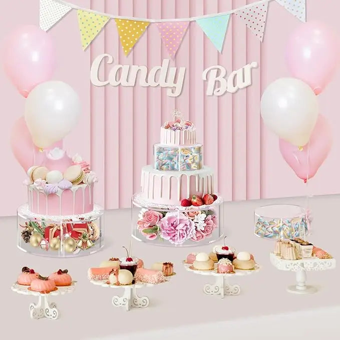 Clear acrylic cake display stands with various desserts and balloons for a candy bar theme