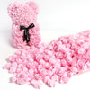 A pink foam rose bouquet with a black ribbon and a loose bulk pack of pink rose petals.