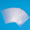 A stack of crystal clear protective card sleeves is displayed against a bright blue background.