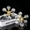 Gold molecular sculpture desk decor featuring clear glass spheres on a white box.