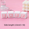 Set of three white cube cake toppers with pink letters B A B Y