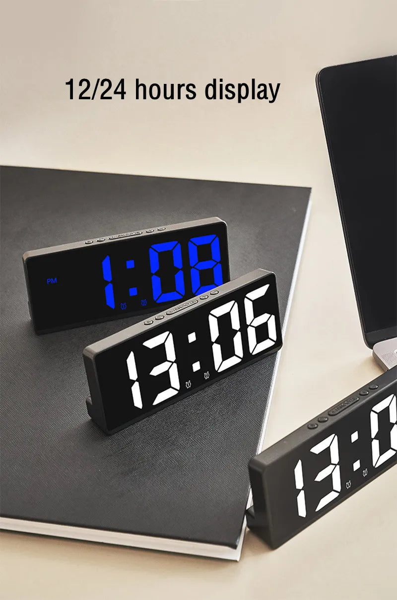 A black digital alarm clock displaying 1:08 on a dark surface with text indicating a 12/24 hours display.