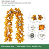 Artificial maple leaf garland featuring yellow and orange leaves and rattan vines for autumn home decor