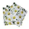 A stack of white and yellow daisy patterned disposable napkins.