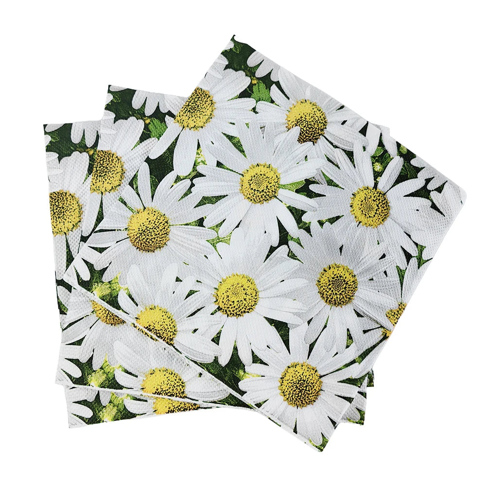 A stack of white and yellow daisy patterned disposable napkins.