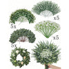 A collection of artificial eucalyptus leaves and small white flowers arranged in bouquets for home decor.