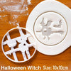 White silicone cookie cutters and fondant stamps shaped like witches on a wooden surface.