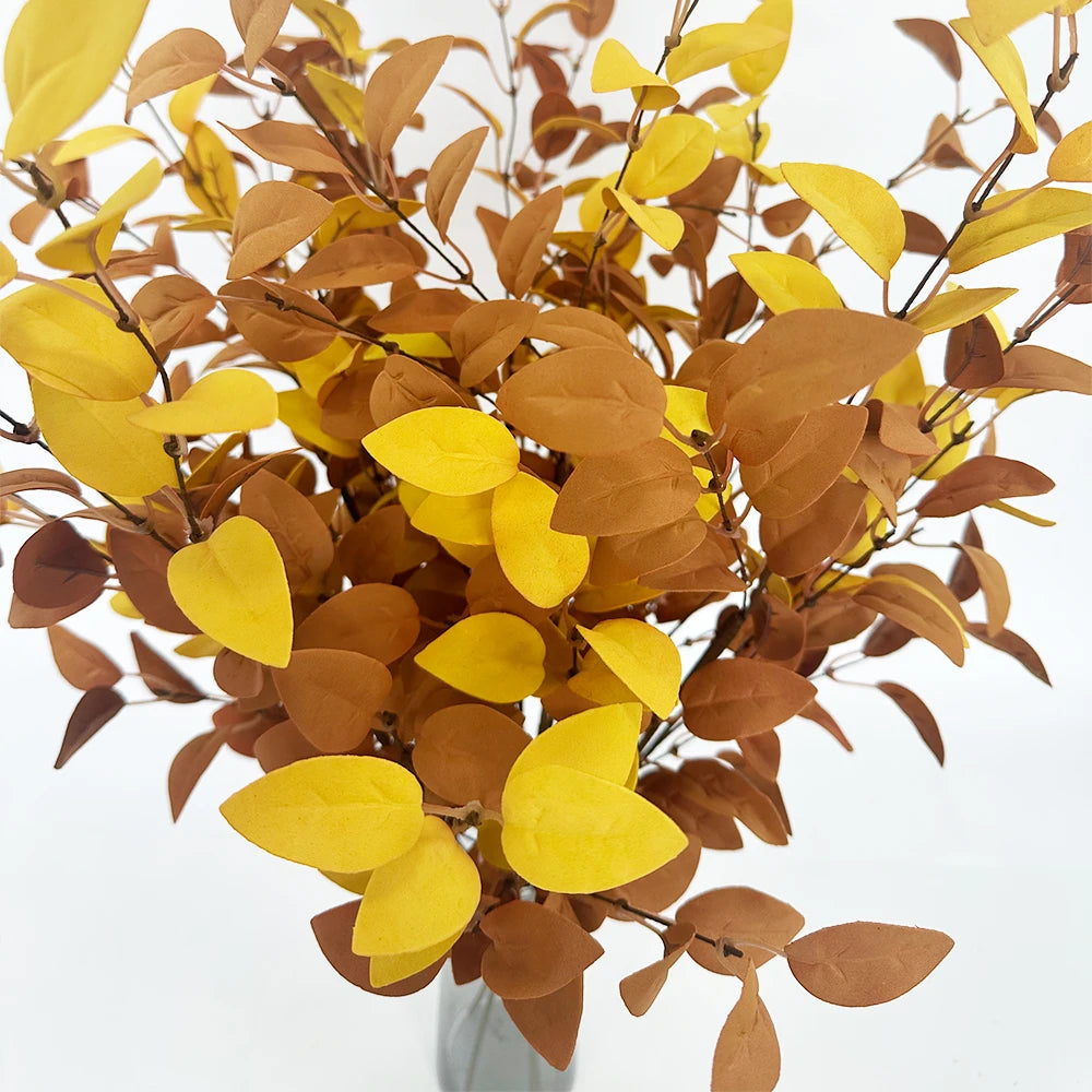 Dried artificial eucalyptus stems featuring warm yellow and brown leaves for autumn decor