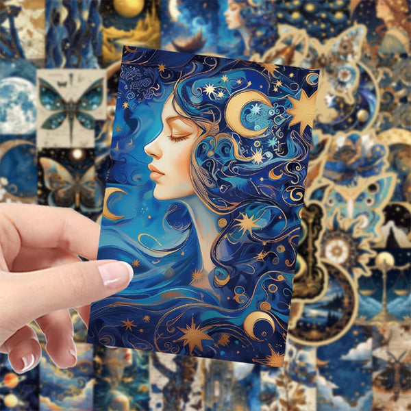A hand holds a square sticker pack featuring a blue and gold illustration of a woman with celestial elements on a dark backgr