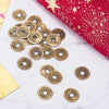 A pile of antique Chinese Feng Shui coins scattered on a white marble surface next to a red fabric.