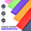 A display of eleven colored crepe papers, including pink, lime green, purple, orange, and red, stacked for craft projects.
