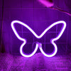 A white neon sign shaped like a butterfly is illuminated against a purple tiled background.