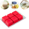 A collection of various colored wax melts and molds, including white, blue, yellow, and red, displayed in a clear plastic cla