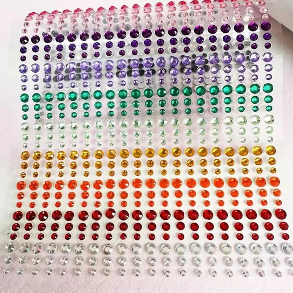A grid of various colored glitter gems used for stick-on facial tattoos.