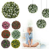 A collection of artificial rose ball decorative floral spheres in various shades of green and pink are displayed.