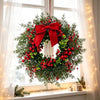 A festive wreath made of artificial pine and eucalyptus greenery decorated with bright red berries, displayed by a window.