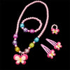 A set of pink and purple beaded jewelry including a necklace and butterfly hair clips.