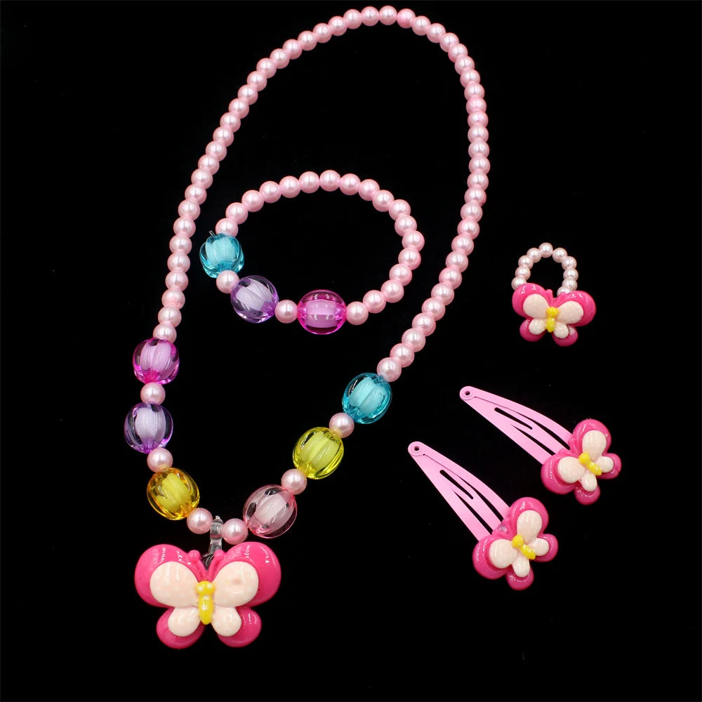 A set of pink and purple beaded jewelry including a necklace and butterfly hair clips.