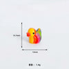 A small, colorful resin duck decoration with a yellow body and green back, shown against a white background.