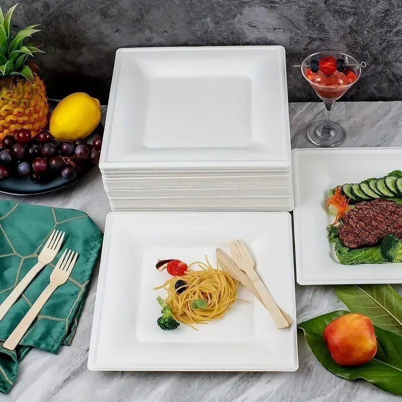 A stack of white square paper plates is displayed next to a glass of fruit salsa and a plate of grilled meat.