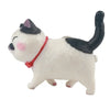 A white and black cartoon cat figurine wearing a red collar, designed as a refrigerator magnet.