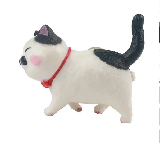 A white and black cartoon cat figurine wearing a red collar, designed as a refrigerator magnet.