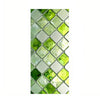 A close-up of retro European green leaf privacy window film with a diamond pattern featuring shades of green and silver.