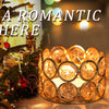 A close-up of a festive holiday scene featuring a decorated Christmas tree and glowing gold votive candle holders.