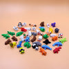 A collection of colorful 3D printed cartoon animal figurines, including bears, cats, and other creatures.